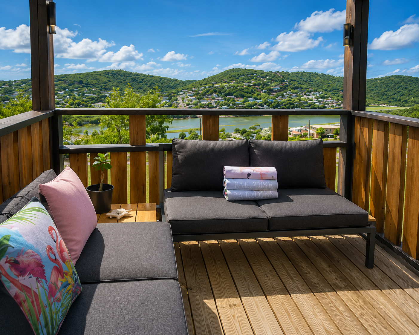 Private balcony with lounge seating and panoramic views over the green hills and bay