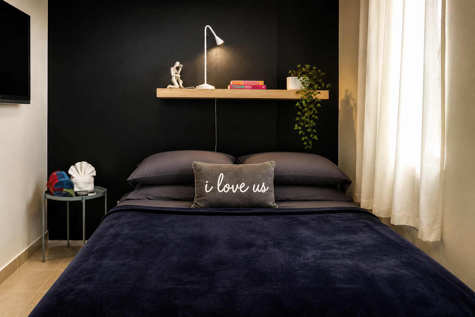 Gibraltar bedroom with a dark accent wall, soft lighting and a comfortable queen bed